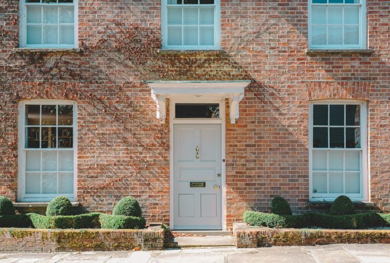 Georgian red-brick townhouse with a pale blue front door