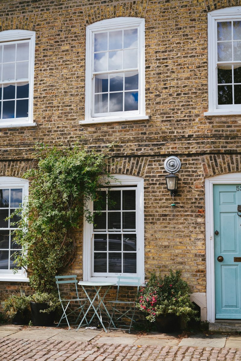 Brick period property with arched windows and teal front door