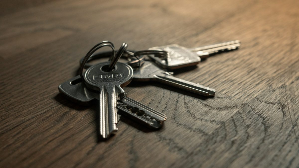 Set of property keys resting on a wooden surface