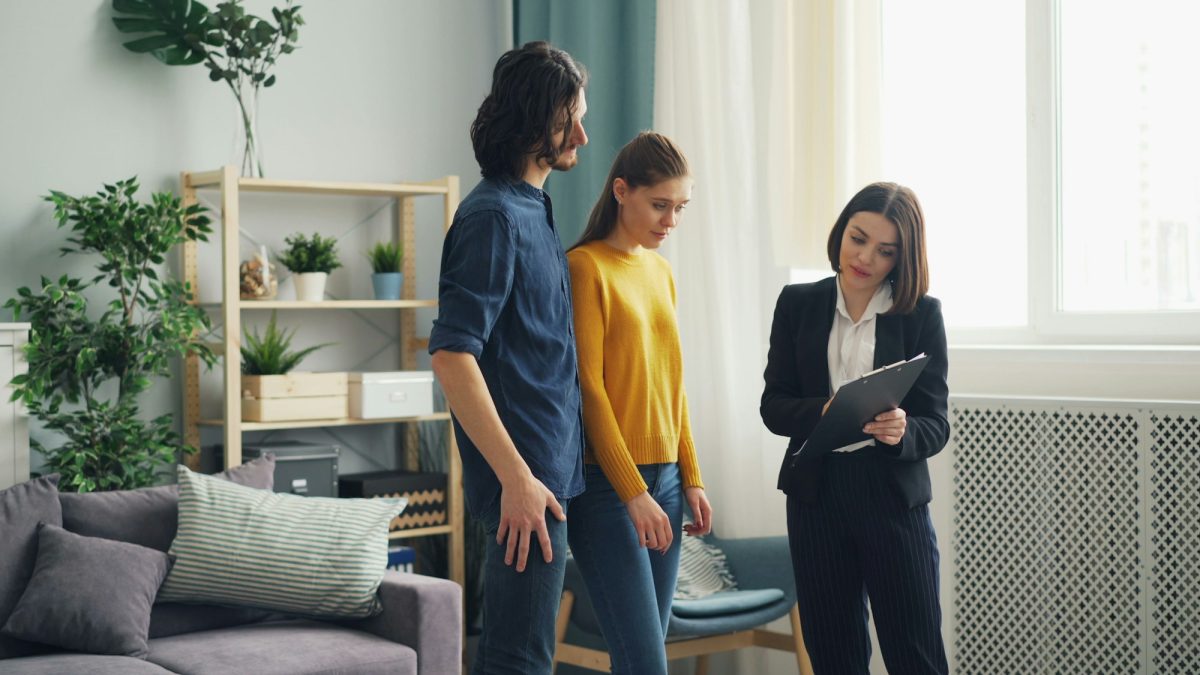 Letting agent showing prospective tenants around a property