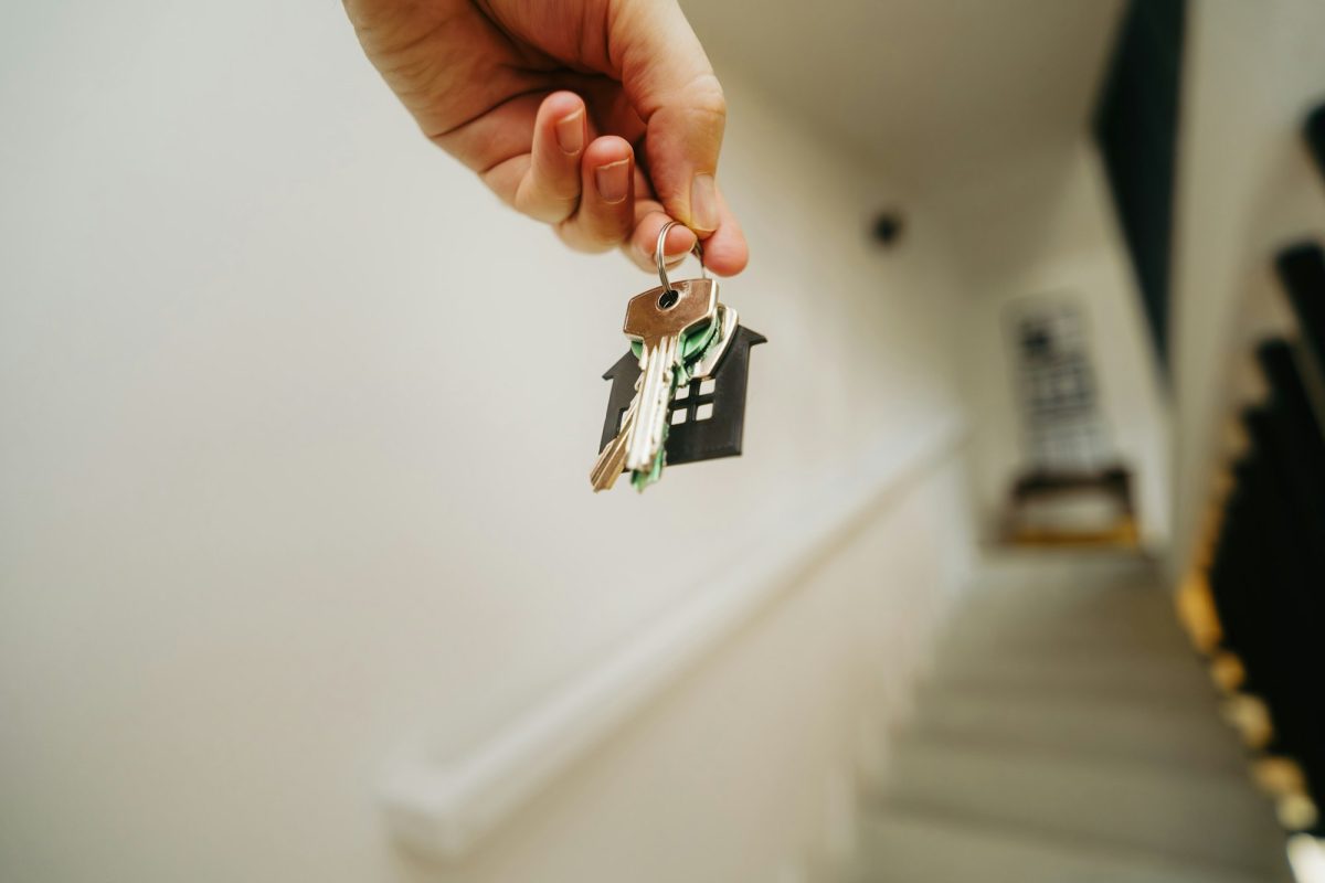 Keys being handed over to a new tenant in a bright hallway